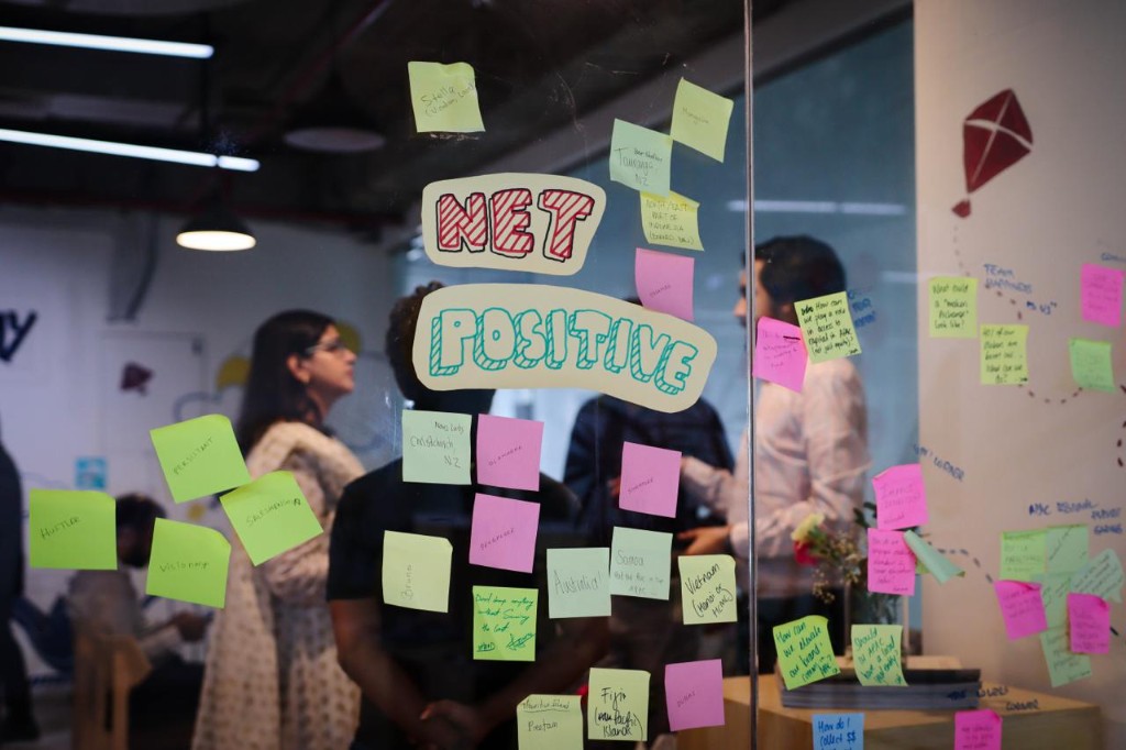 Collaborative planning session with Net Positive signage